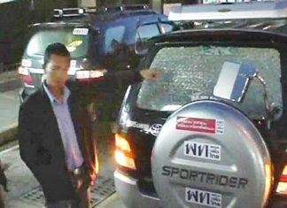 Police examine the smashed window.